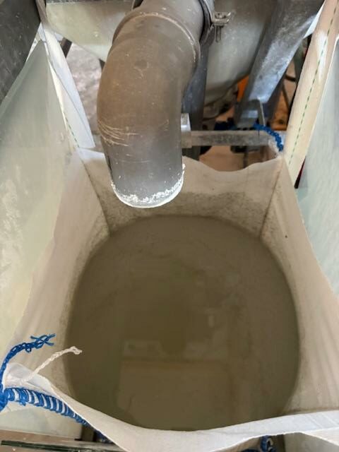 Eau usée saturée en silice stagnante dans un bigbag, montrant la turbidité élevée